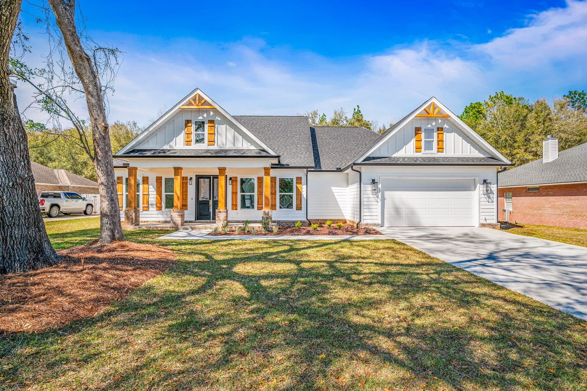 The Cameron, a white modern farmhouse with cedar porch posts and shutters